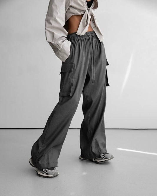 charcoal cargo pants with wide legs and soft drape.