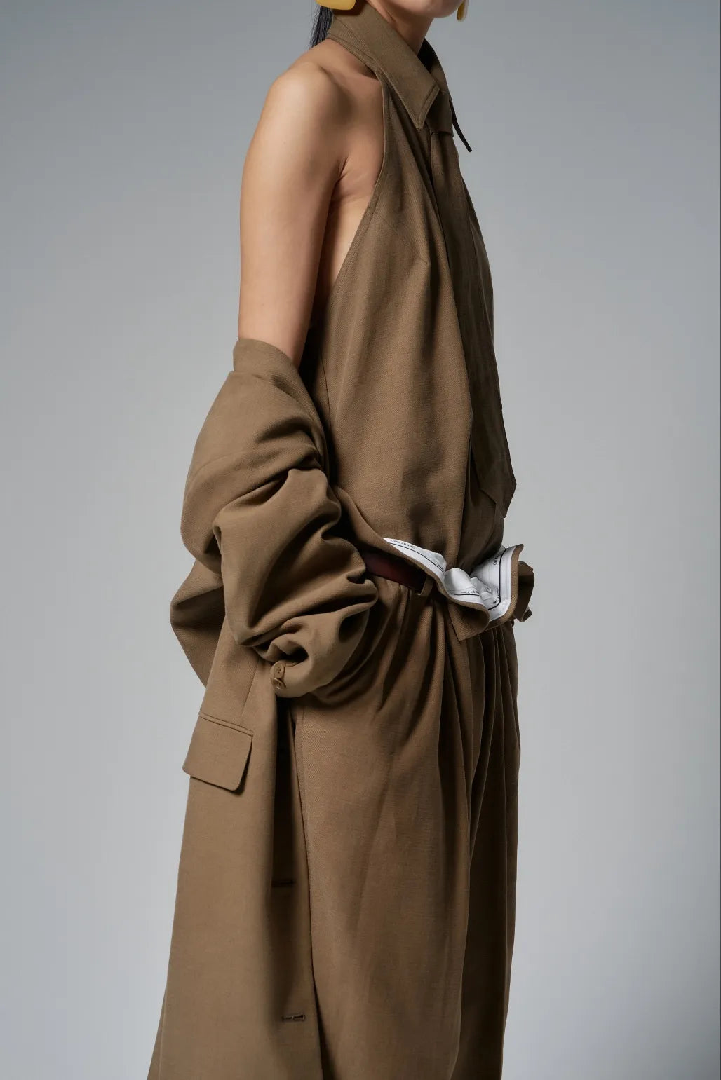 Side view of the tie-front halter shirt, revealing the open armhole and sculpted halter neckline.