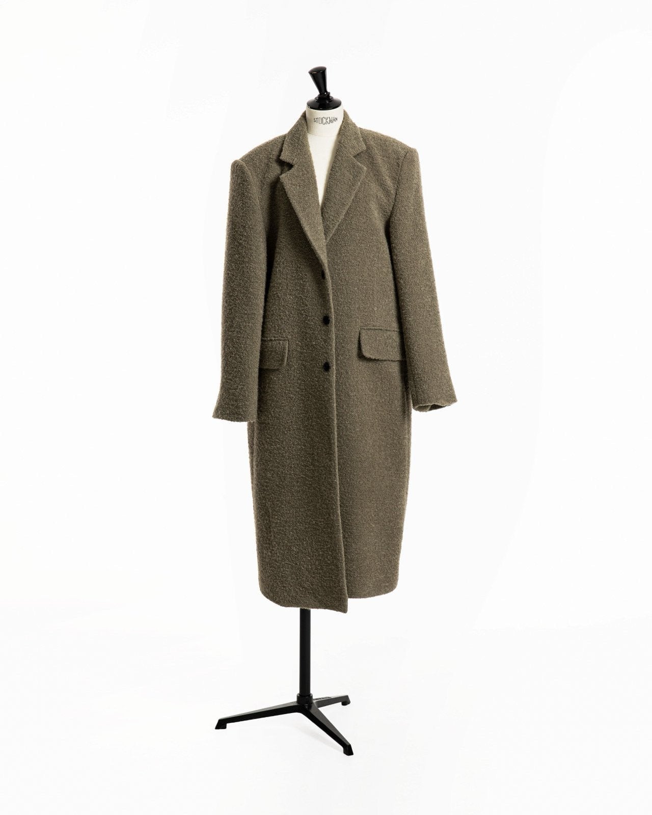 Khaki beige oversized bouclé alpaca wool maxi coat displayed on mannequin, showing structured shoulders and elongated three-button silhouette