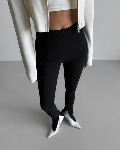 Structured ribbed black leggings styled with cropped white jacket -minimalist front close-up