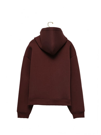 Back view of burgundy neoprene hoodie showing sculptural hood and boxy cut