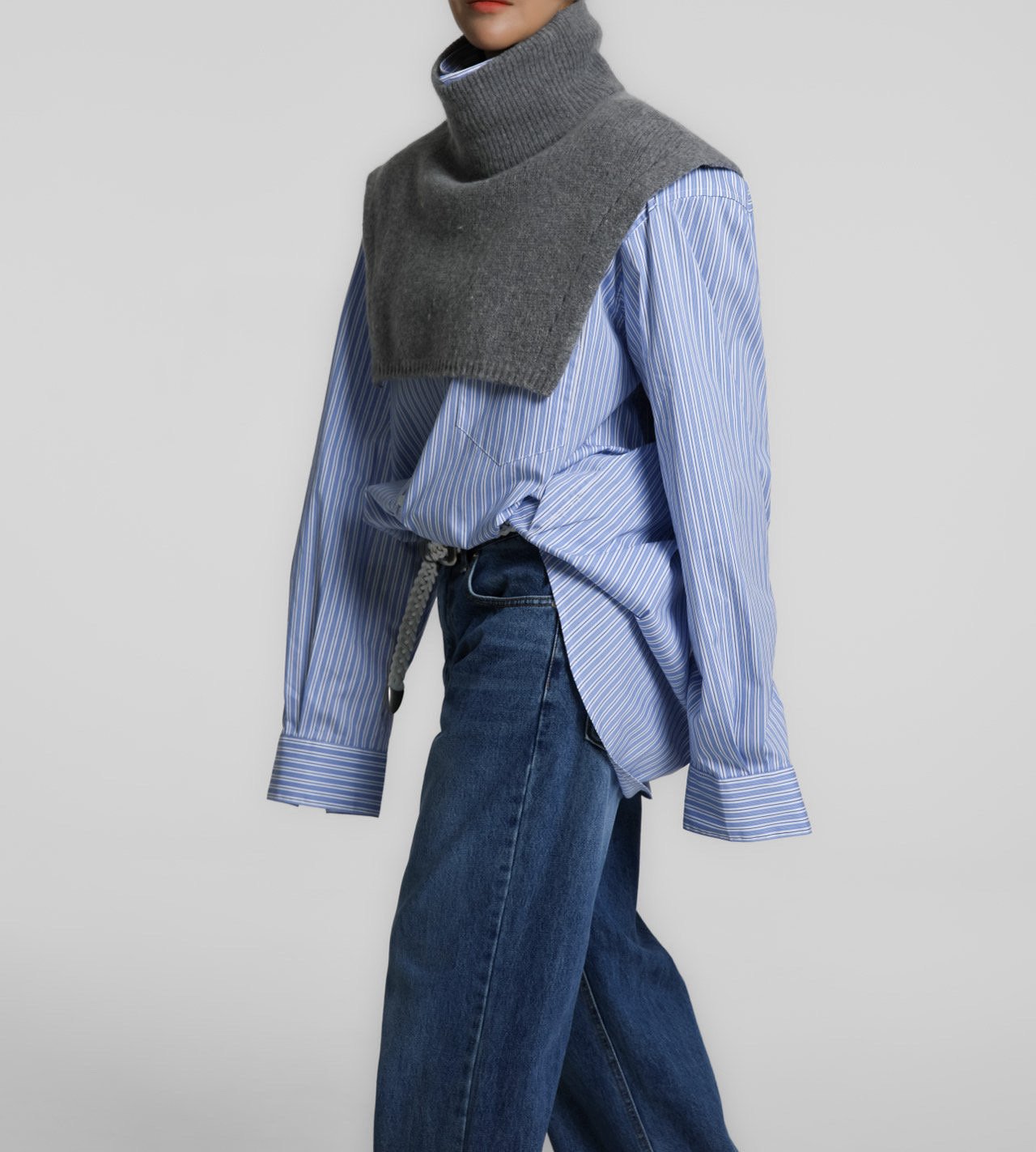 Model in motion wearing the Turtleneck Wool Cape Knit, highlighting its modern cropped proportions and high ribbed turtleneck.