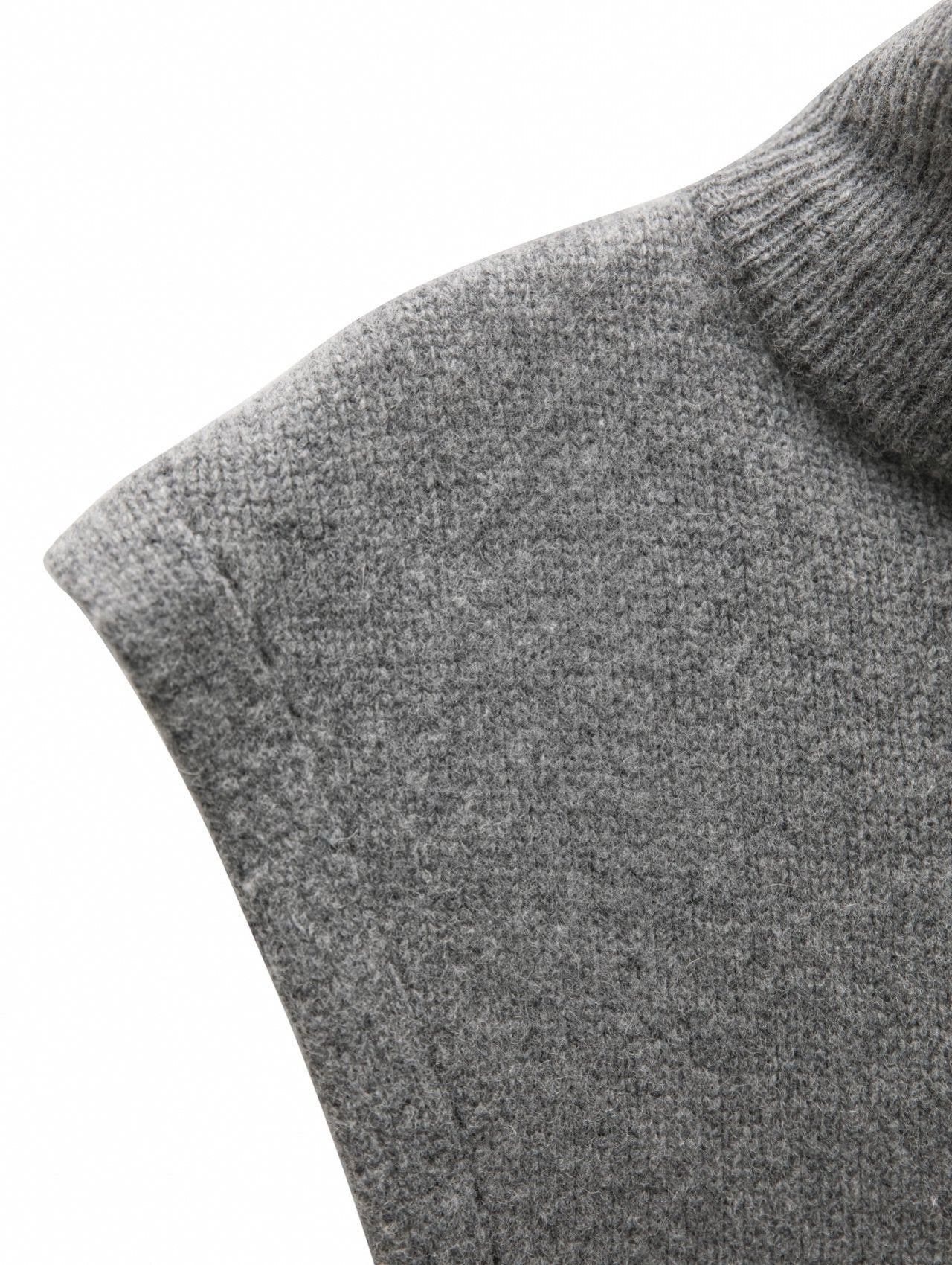 Close-up detail of the ribbed turtleneck texture in soft super fine wool blend.