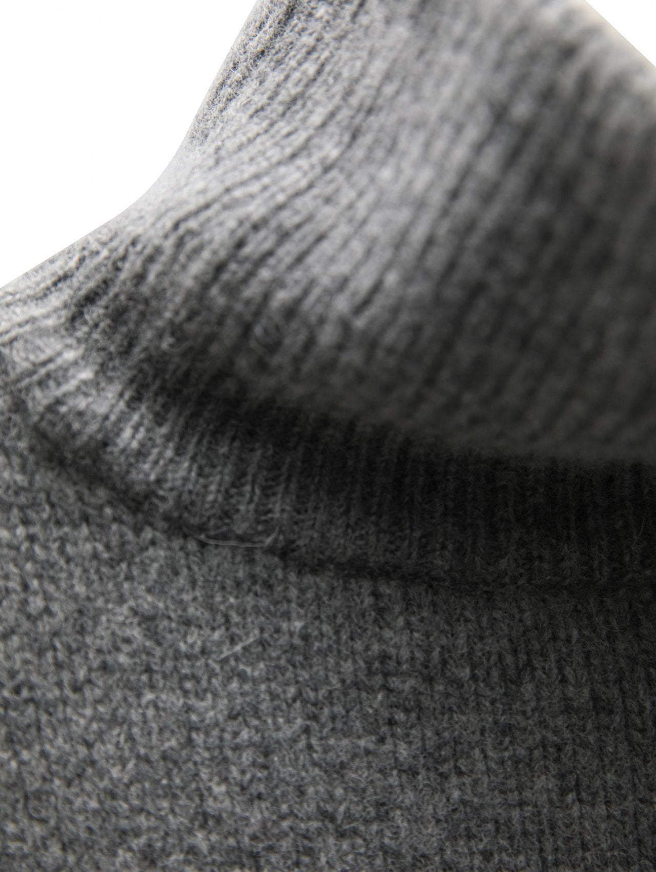 Detailed knit texture of the Turtleneck Wool Cape Knit emphasizing its premium wool blend and refined craftsmanship.