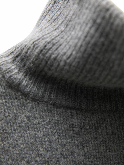 Detailed knit texture of the Turtleneck Wool Cape Knit emphasizing its premium wool blend and refined craftsmanship.