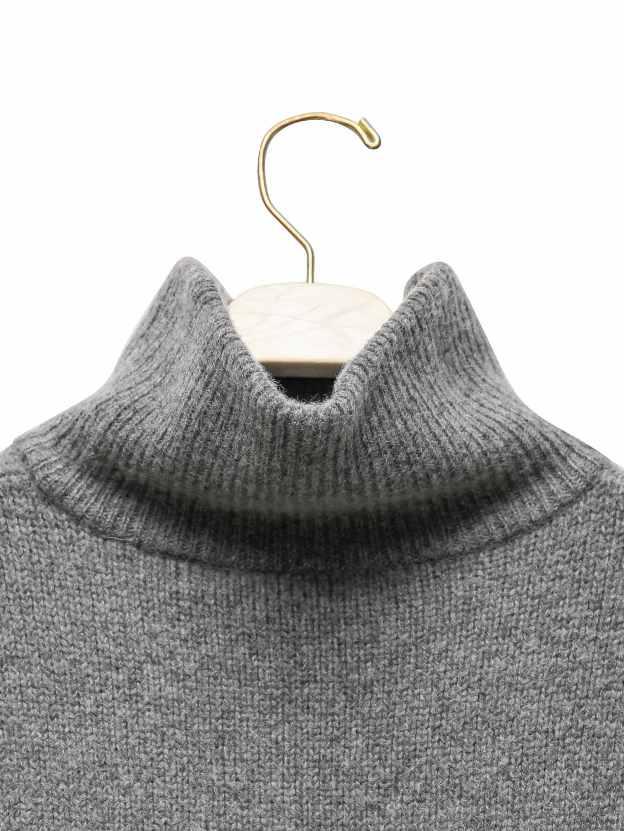 Close-up detail of the ribbed turtleneck texture in soft super fine wool blend.