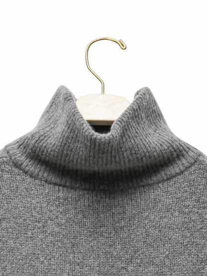 Close-up detail of the ribbed turtleneck texture in soft super fine wool blend.