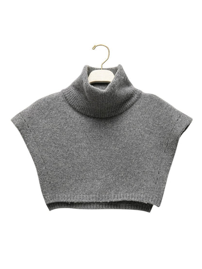 Turtleneck Wool Cape Knit displayed on hanger to show structure and form.