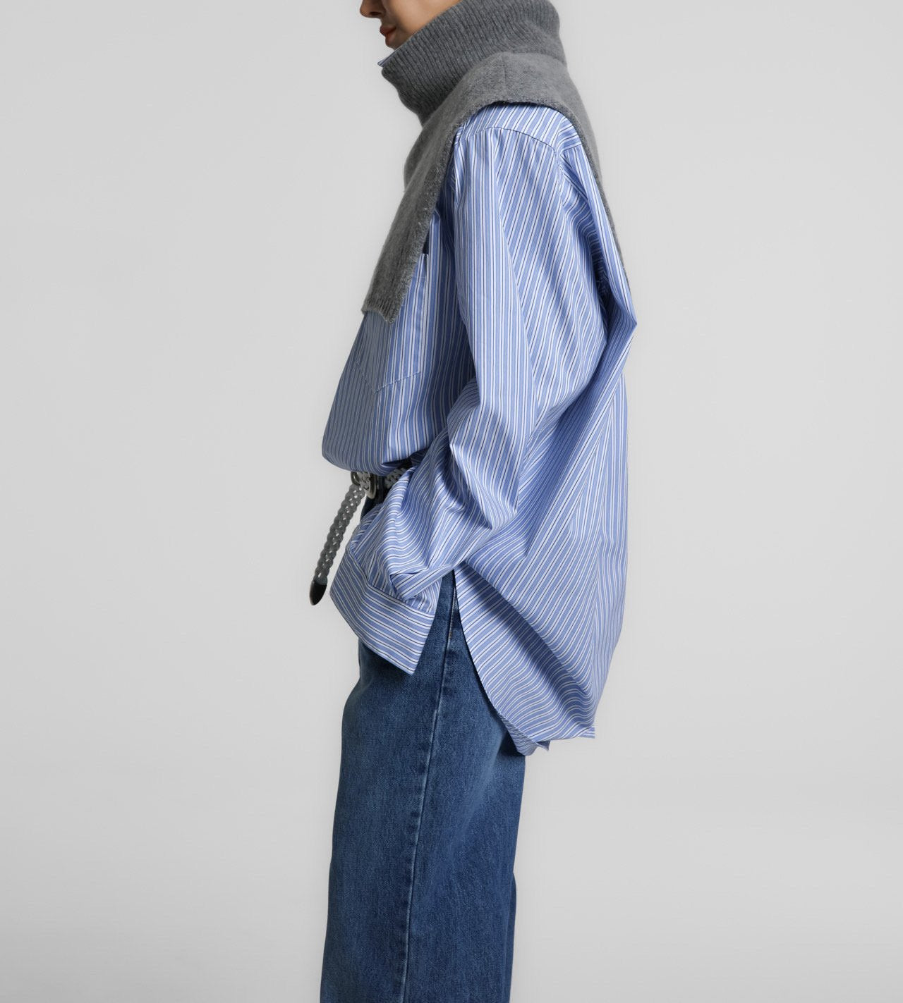 Side angle of the Turtleneck Wool Cape Knit revealing the structured neckline and clean drape over the shoulders.