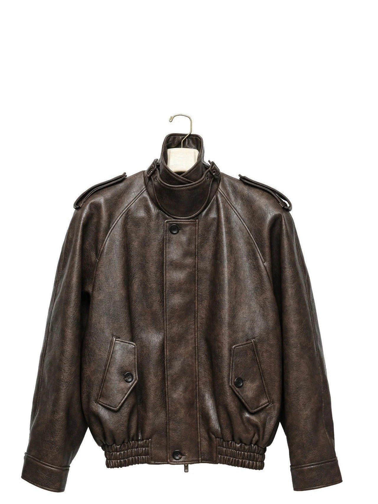 Oversized brown vegan leather bomber jacket on hanger, showcasing bold structure and tailored silhouette