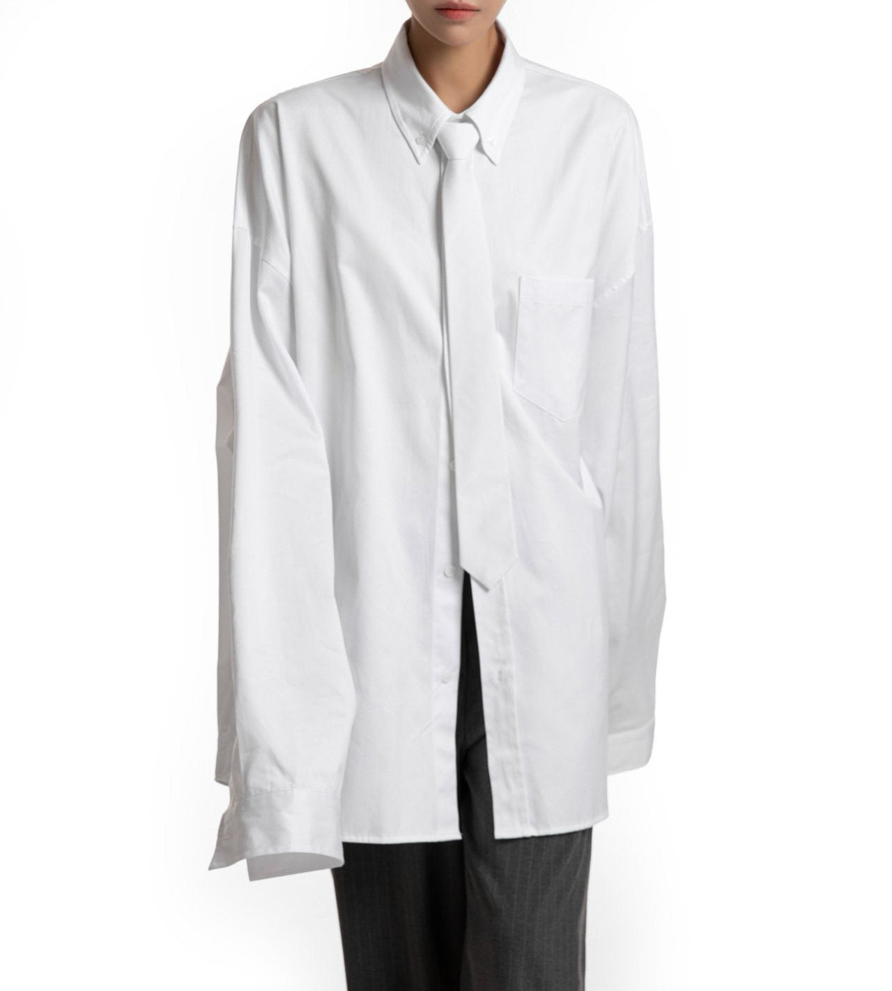 Front view of oversized white shirt with structured collar — minimalist wardrobe essential.