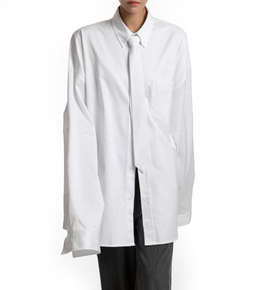 Front view of oversized white shirt with structured collar — minimalist wardrobe essential.