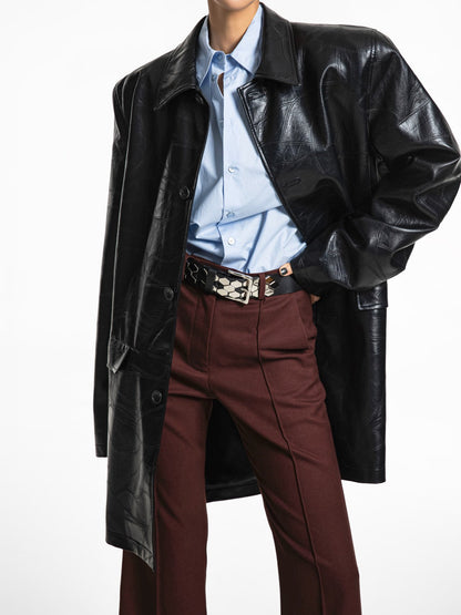 Front view wearing oversized black patchwork vegan leather coat