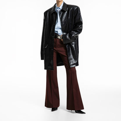 Full-body look styling the oversized black vegan leather coat