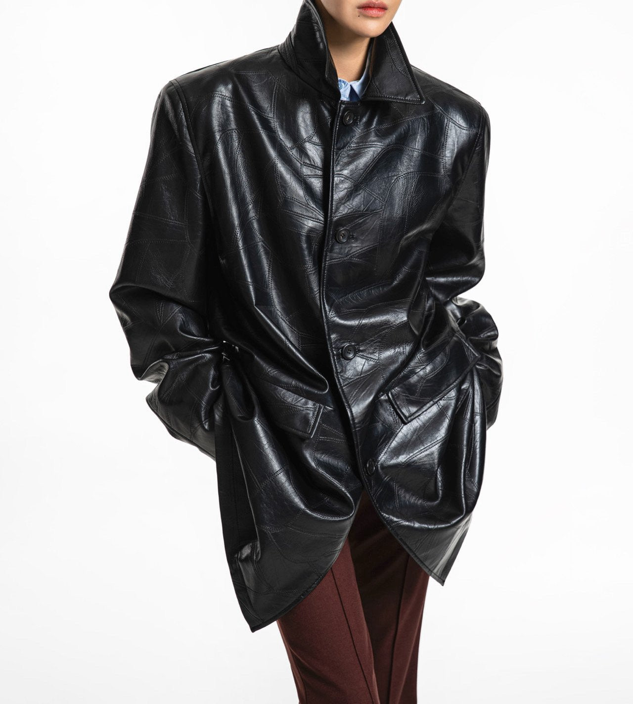 Buttoned front view of oversized patchwork vegan leather coat