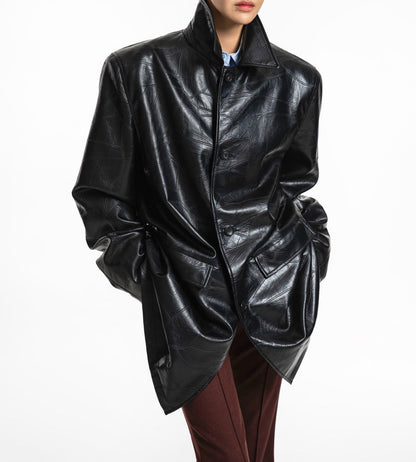 Buttoned front view of oversized patchwork vegan leather coat