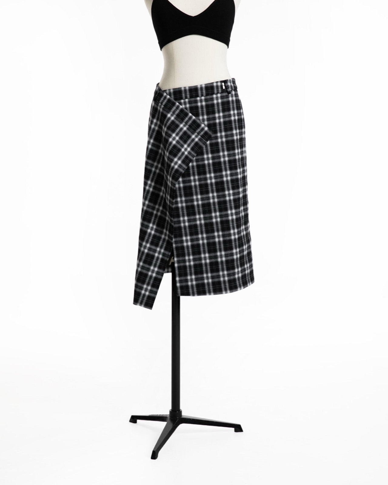 Angle view of plaid wrap skirt showcasing structured wrap panel.