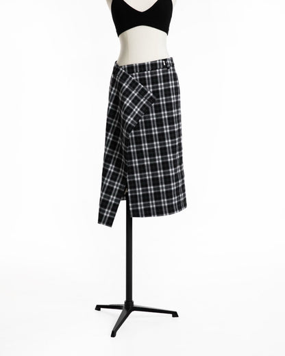 Angle view of plaid wrap skirt showcasing structured wrap panel.