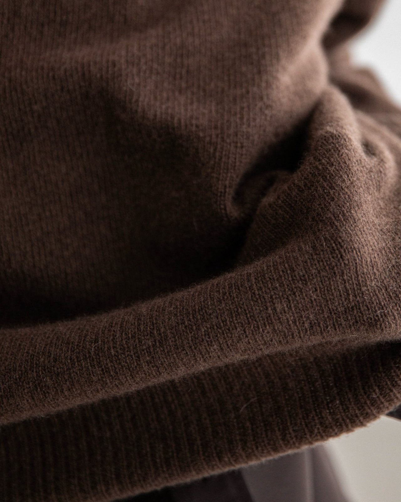 Soft fine-knit texture of the wool cashmere blend showcasing subtle sheen and warmth