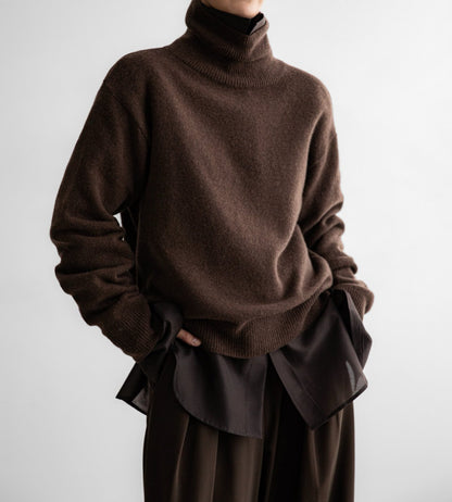 Model wearing chocolate brown high neck wool knit styled with tonal trousers – minimalist fit